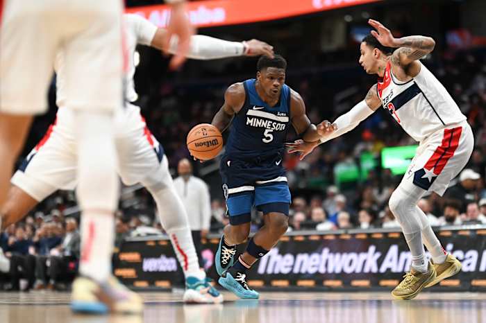 Minnesota Timberwolves guard Anthony Edwards (5) makes a move to the basket on Washington Wizards forward Kyle Kuzma (33) during the fist half at Capital One Arena.